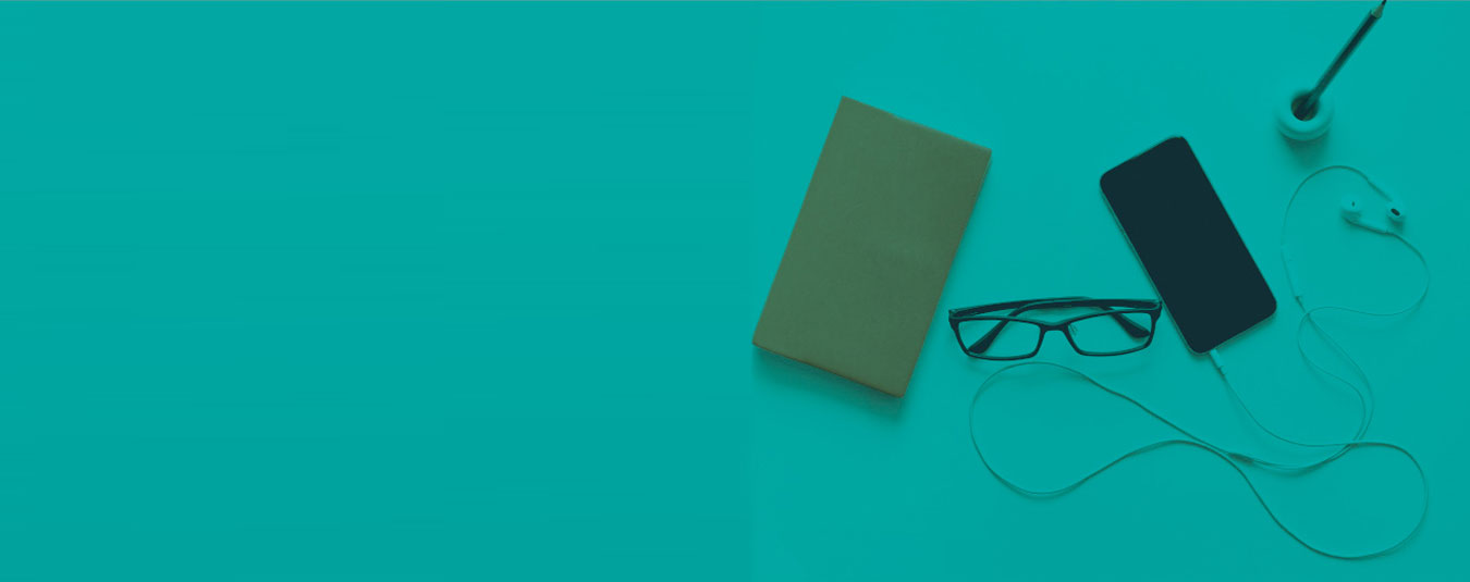 Flat lay on teal background showing a notebook, glasses, smartphone, and earphones with cable, minimalist and calm mood